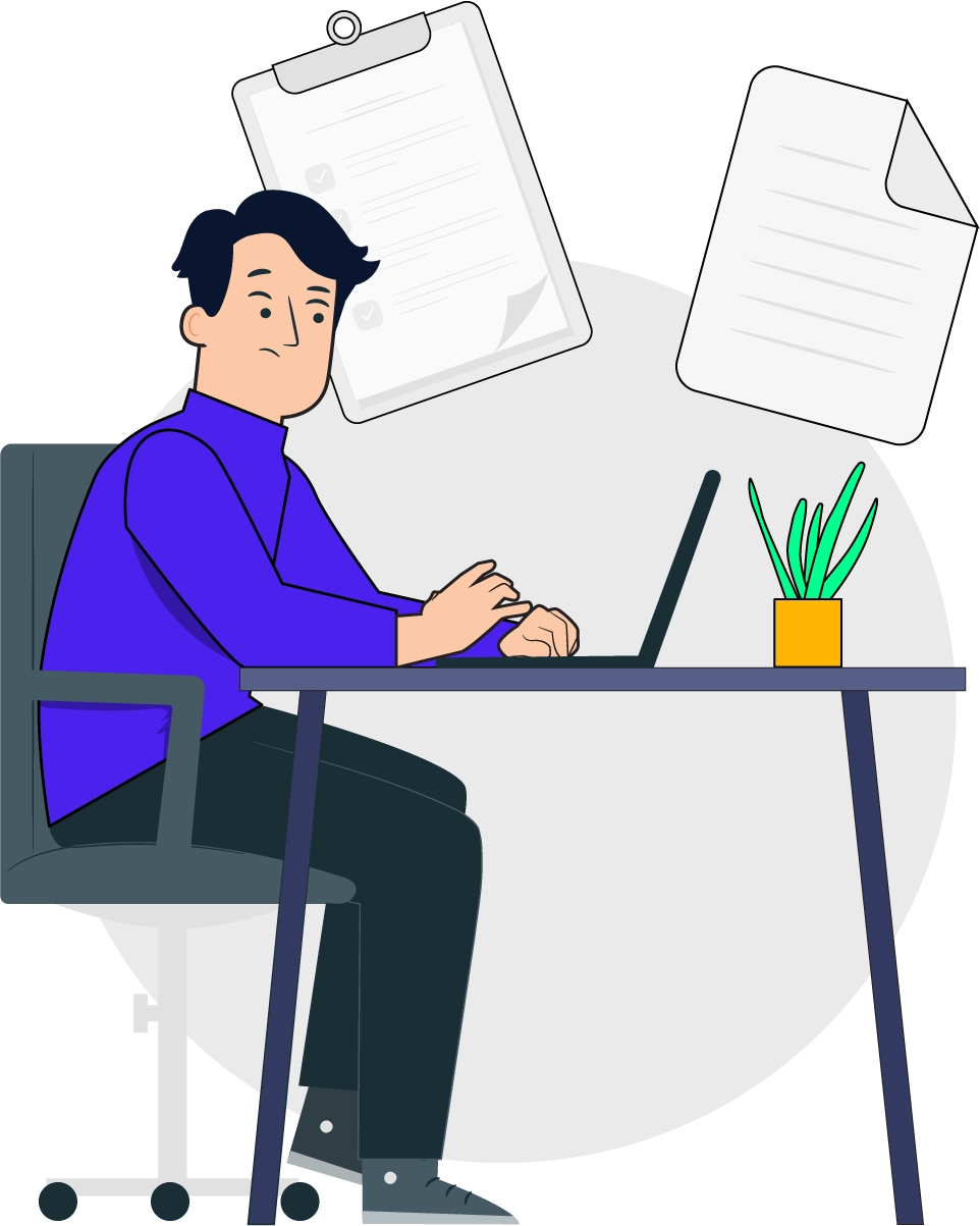 A man seated at a desk, working on a laptop surrounded by documents and qualifications.
